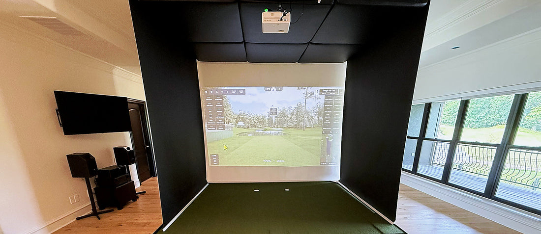 Golf simulator impact screen deployed and centered on the hitting bay wall