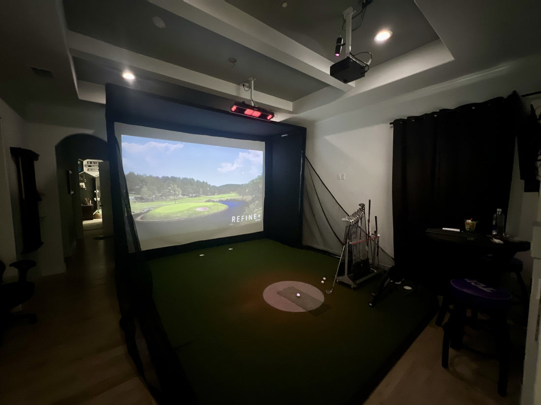 Installed retractable golf simulator screen mounted to a garage ceiling