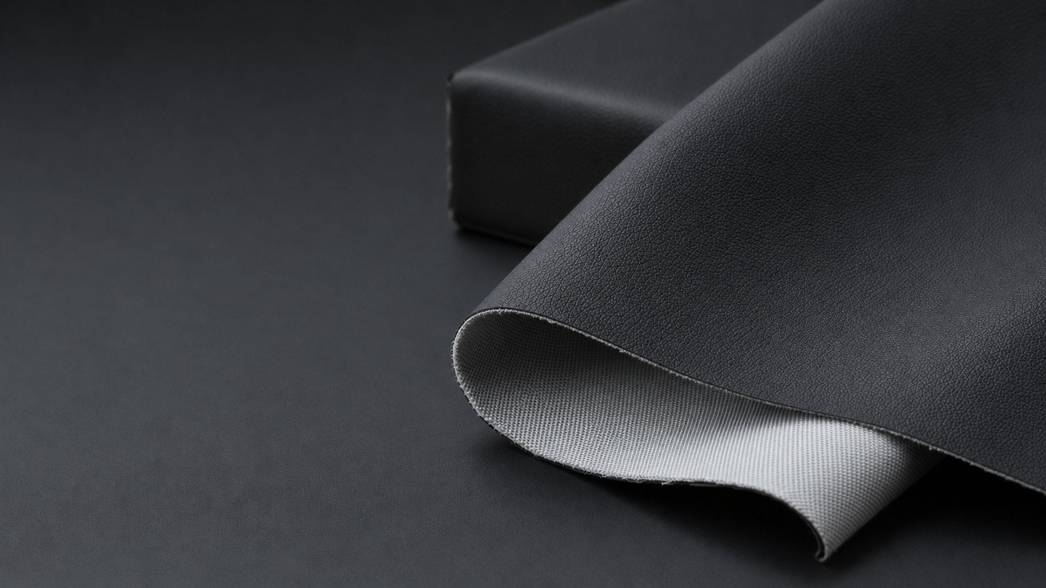 Impact padding panel material, leather look face with fabric backing