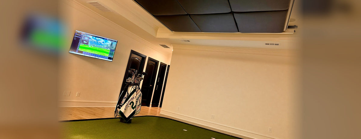 The Home Fairway screens retracted into the ceiling, the bay back to a normal room with a golf bag and turf floor