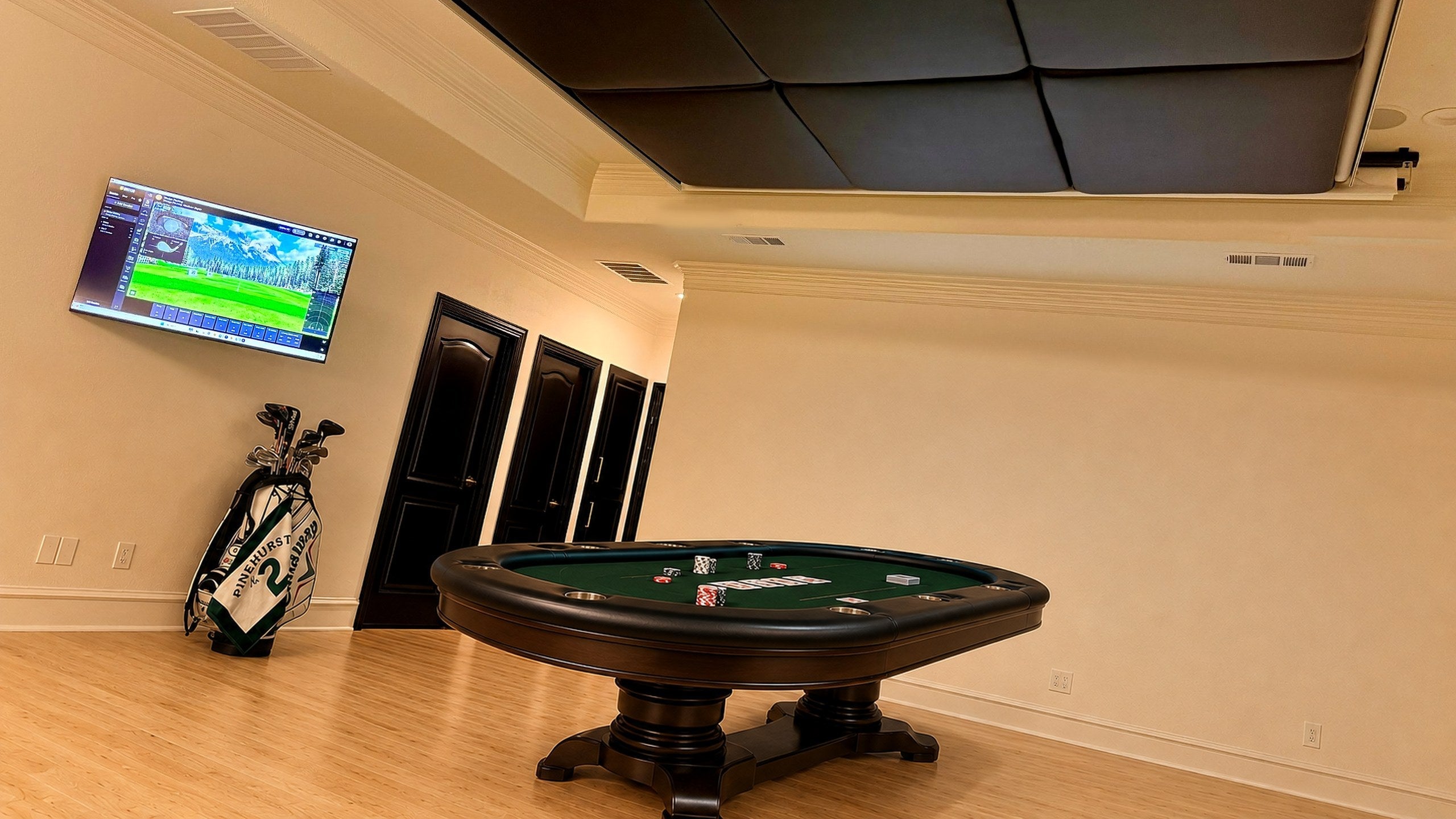Same room with the screens retracted, poker table back in play